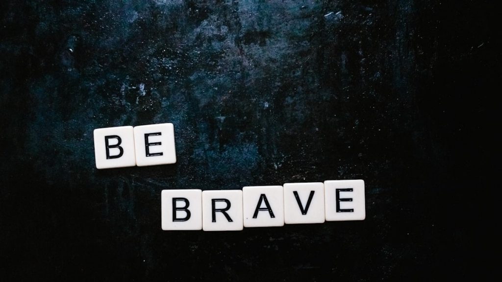 Be brave spelt out using Scrabble letters flatlay